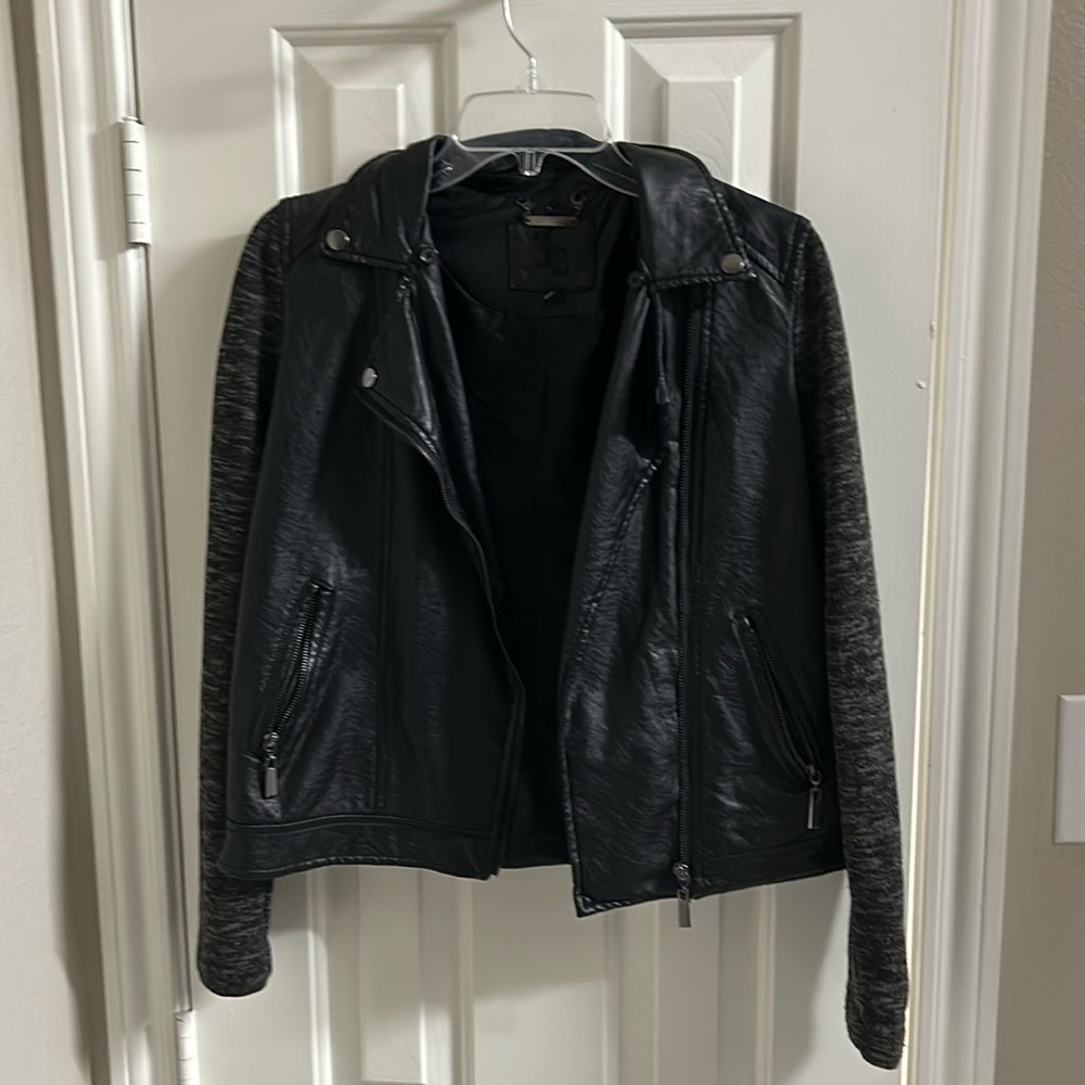 Leather jacket/sleeves are cloth material. Black leather.Sleeves are black&grey
